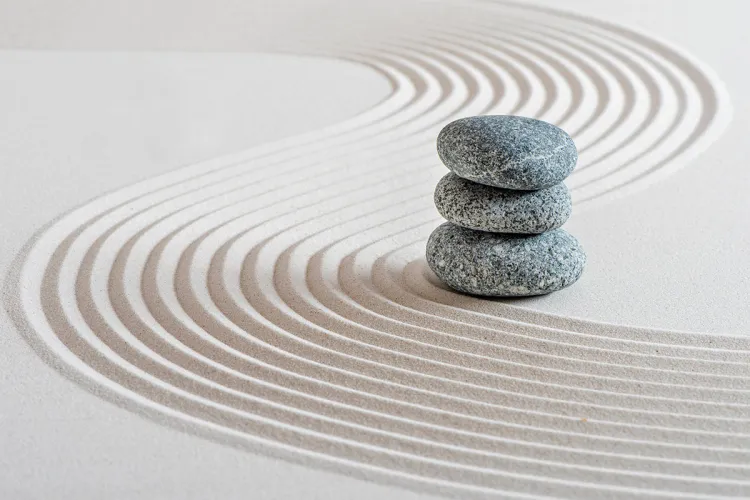 Zen stones in sand symbolizing medical wellness and holistic wellbeing at Private Palace Hotels & Resorts
