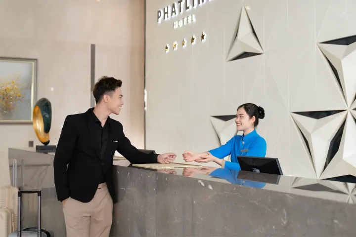 Guest at the reception of a Private Palace hotel during check in for his holiday