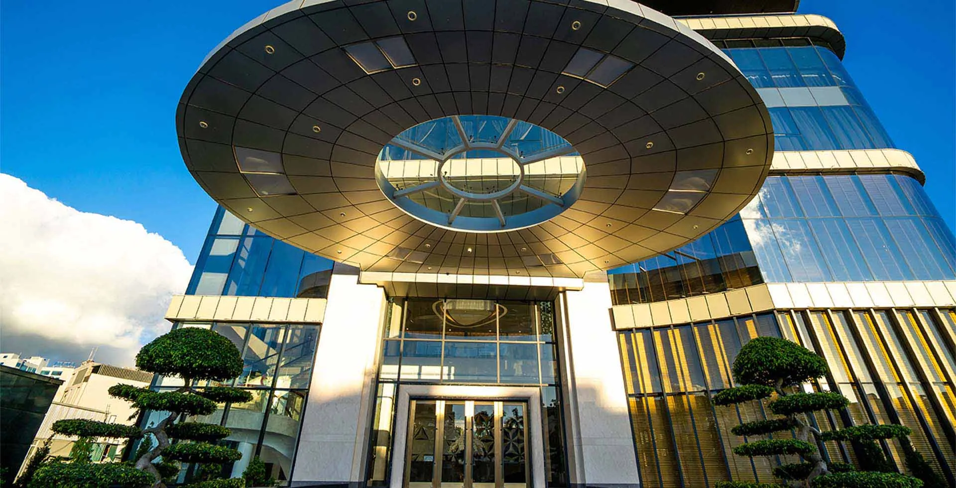 Entrance of Phat Linh Hotel in Ha Long City Vietnam with modern glass facade and circular canopy