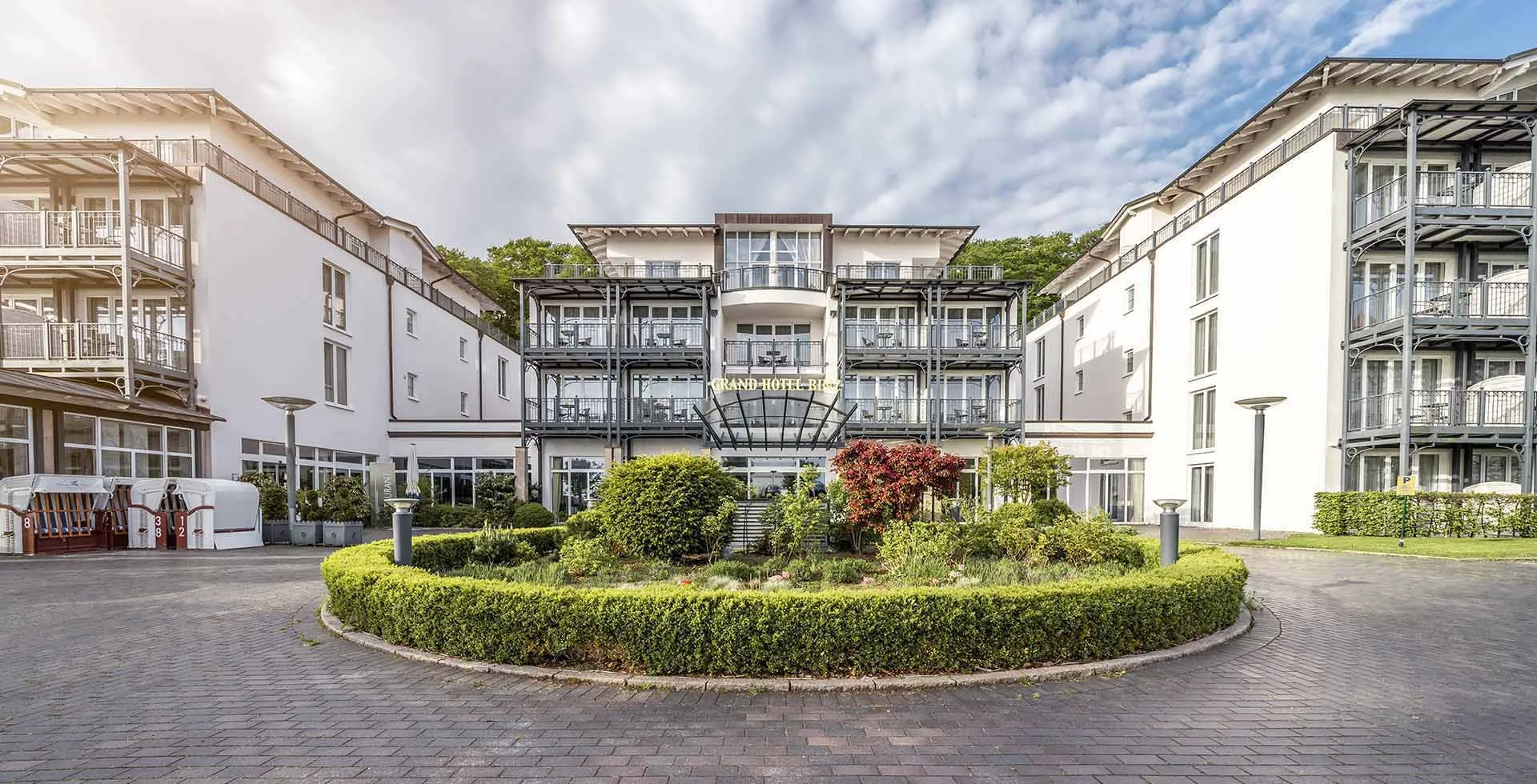 Front view of Grand Hotel Binz in Binz at the Baltic Sea with entrance area and garden courtyard