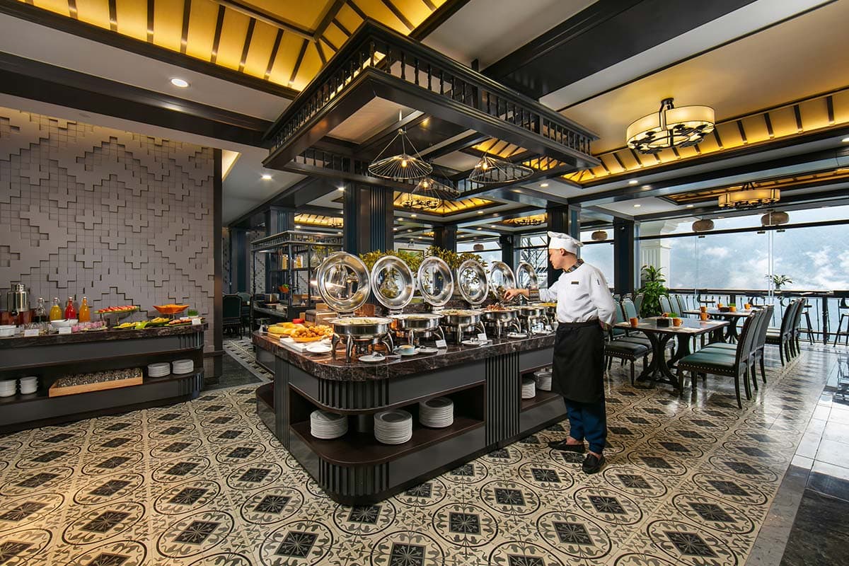 Buffet area in the restaurant of DeLaSol Phat Linh Hotel Sapa with food and chef