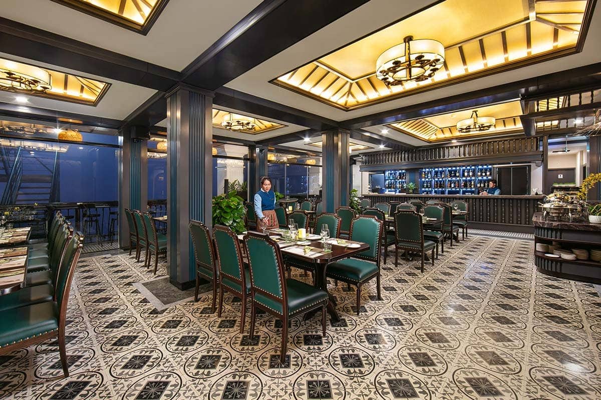 Restaurant with prepared tables and bar at DeLaSol Phat Linh Hotel Sapa