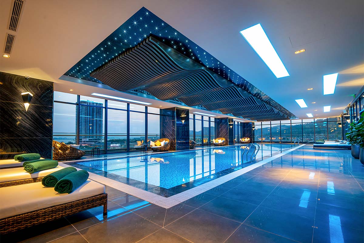 Indoor pool at Phat Linh Hotel Ha Long with loungers and panoramic windows