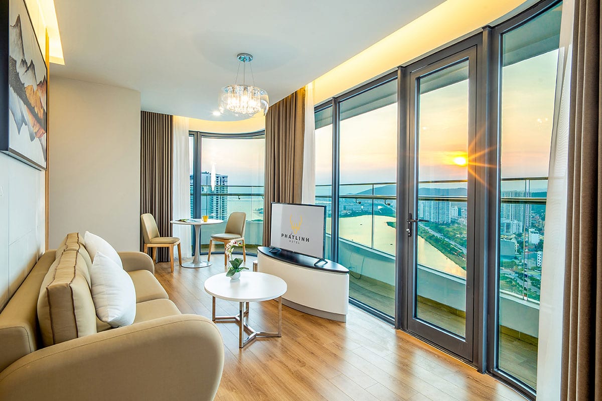 Suite at Phat Linh Hotel Ha Long with living area balcony and sunset sea view