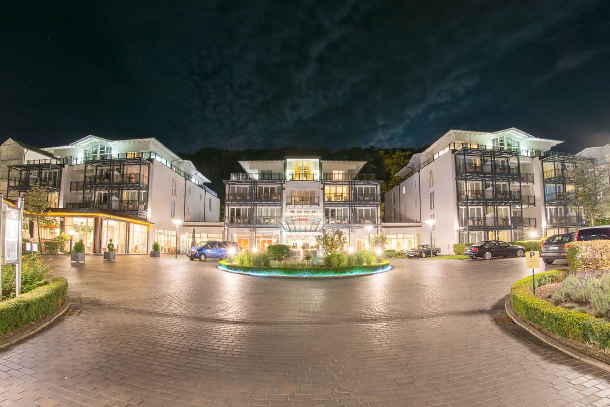 Illuminated entrance of Grand Hotel Binz on Rügen at night with driveway